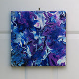 original abstract poured acrylic painting on 12x12" canvas, bright swirling purples, white and rich blues seem energetic, display in varoious orientations