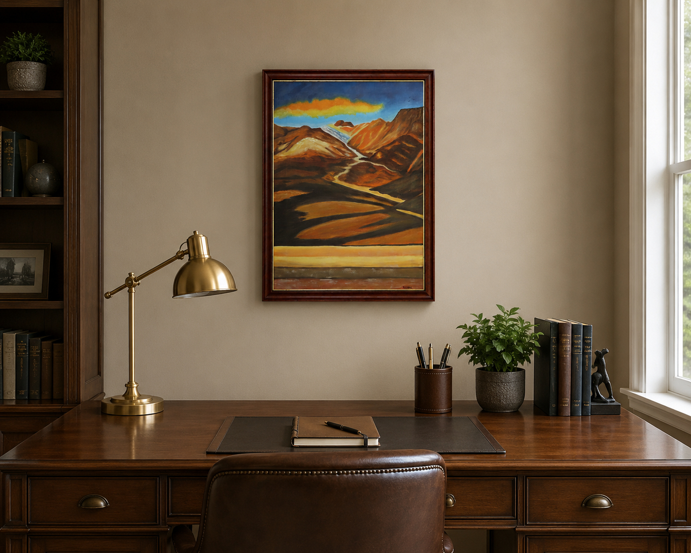 original oil painting of colorful mountains and plains with colorful clouds in sky framed in complementary wood frame, displayed behind desk