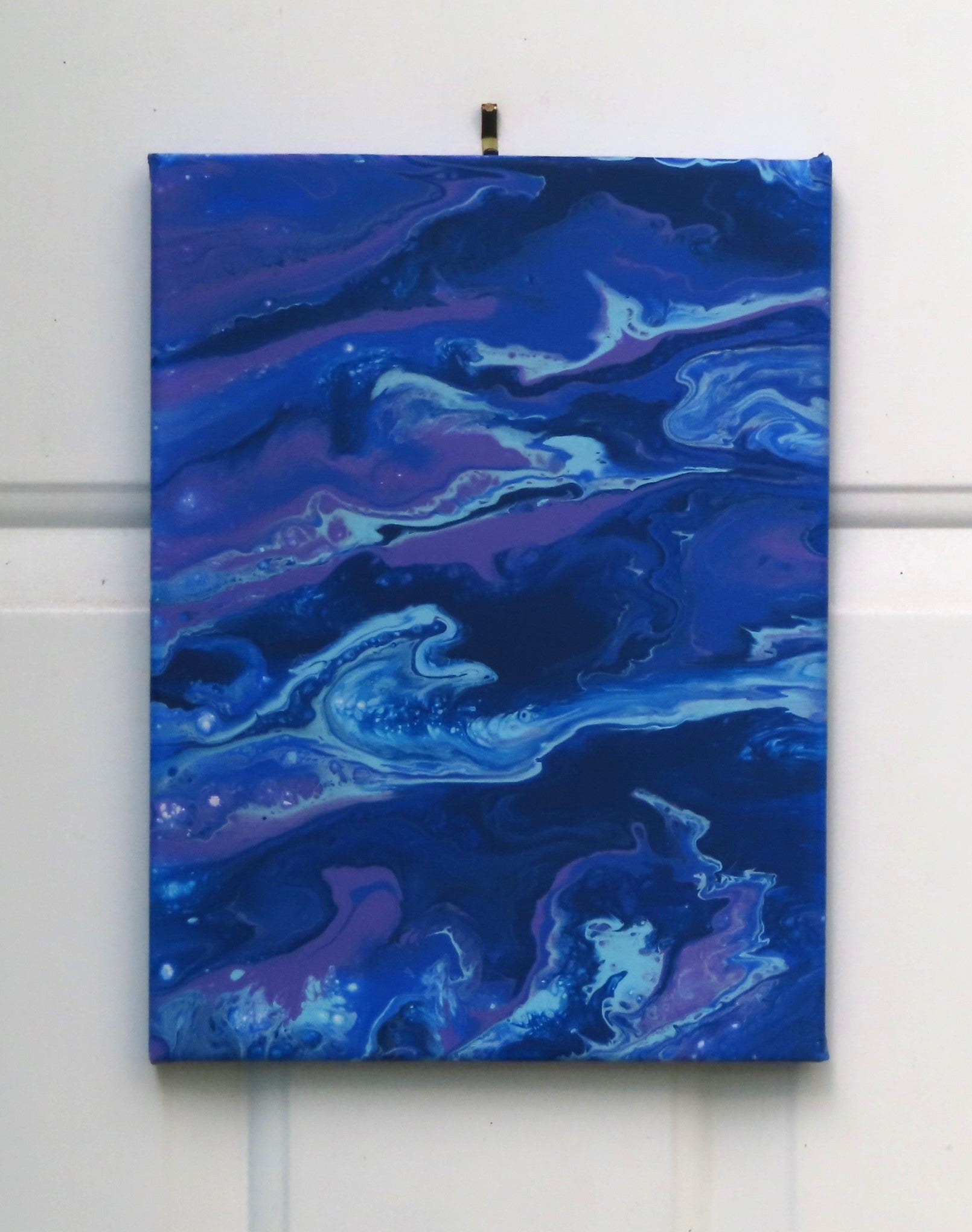 original abstract acrylic poured painting of an alien landscape in rich blues, purples and white accents, 9x12