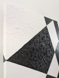 original acrylic painting meaures 12" tall x 24" wide, black and white abstract geometric forms with some coarsely textured shapes, close-up of side