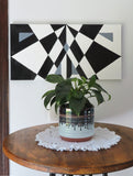 original acrylic painting meaures 12" tall x 24" wide, black and white abstract geometric forms diplayed over small table