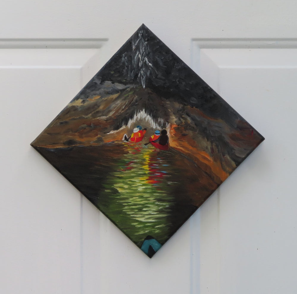original oil painting of kayakers entering a cave system with river, dark water and walls, accented by light reflections and cave formations, unframed presented in diamond presentation