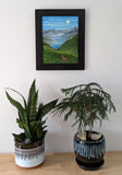 Original oil painting of a misty morning in the mountains, moon, lakes, deer in meadow, framed, shown over table