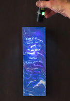 4 inches wide by 12 inches tall, liquid acrylic painting with blues, purple and white, shown here with the secret message lit up with the black light.