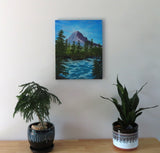 original oil painting, mountain, rushing river, evergreens, unframed, displayed on wall over table