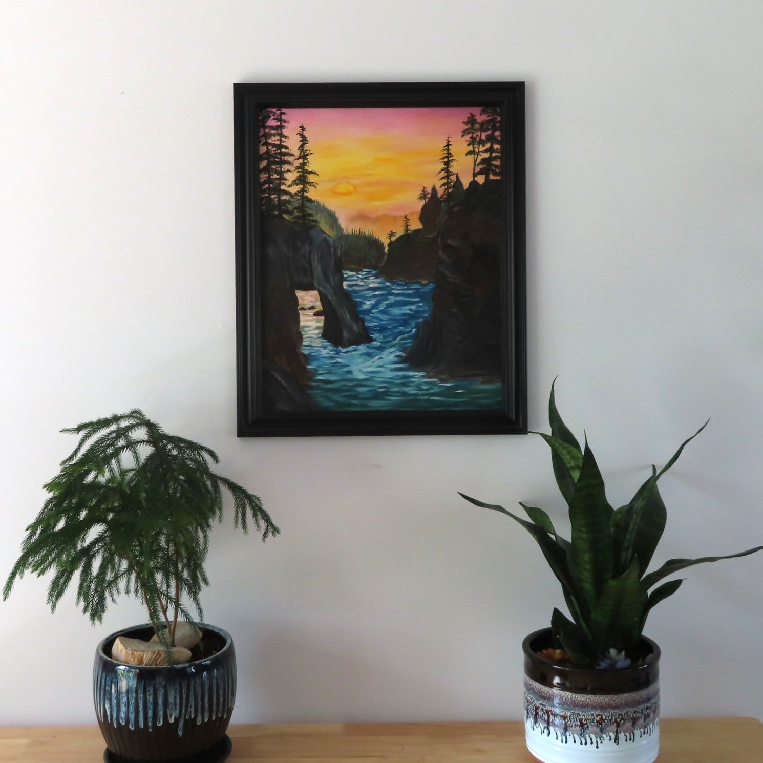 original oil painting, rugged coastline, ocean, lovely sunset and reflection, framed, displayed on wall over table