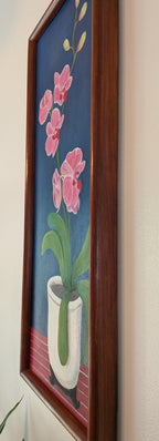 original oil painting on board of pink orchids against a royal blue background, in a white pot, framed in a handmade red chestnut colored frame, a right side view to show the depth of the frame