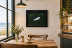 11x14" Original oil painting of a beluga whale in emerald colored ocean, framed, shown in a cafe