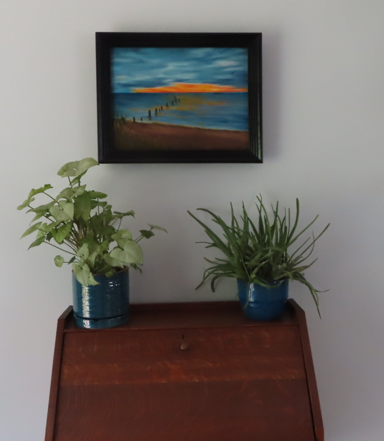 12x16 original oil painting of beach and sunset scene right after the rainstorm, pictured over secretary-desk