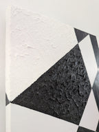 original acrylic painting meaures 12" tall x 24" wide, black and white abstract geometric forms with some coarsely textured shapes, close-up of side