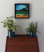 original 12x12" oil painting of Bora Bora with iconic mountain view from beach, framed, shown over secretary desk