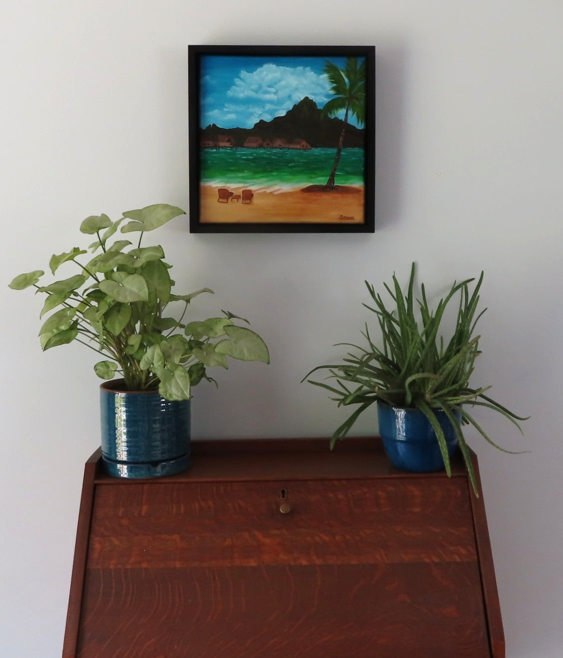 original 12x12 oil painting of Bora Bora with iconic mountain view from beach, framed, shown over secretary desk
