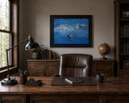 Original oil painting of Humpback whale breaches in front of misty mountains, framed in black, behind desk