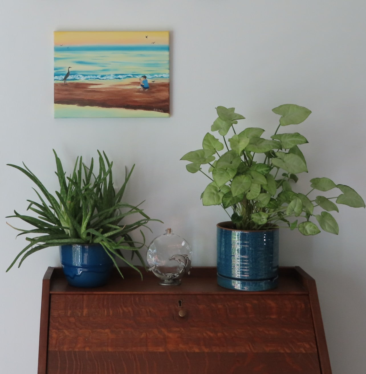 9x12 original oil painting, crane by the seashore pastel sky and reflections on the ocean, pictured over secretary desk
