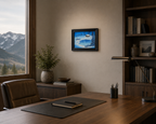 9x12" Original oil painting, snowing, frozen lake, snow drifts, cabin, displayed in an office with a mountain view