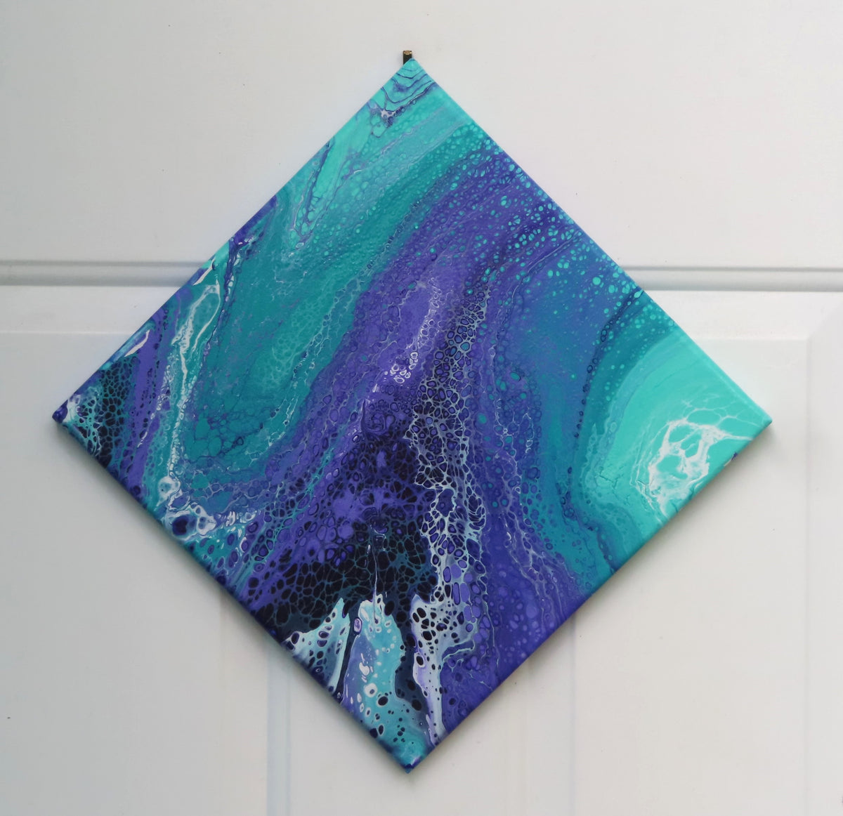 abstract liquid acrylic paint on 12x12" canvas, blues, greens and purples mix and flow in endless movement, can display in various directions.