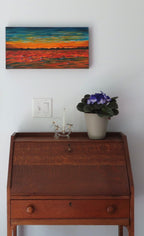 10x20" original oil painting of dolphin pod at sunset, deep cradle canvas, shown over secretary desk