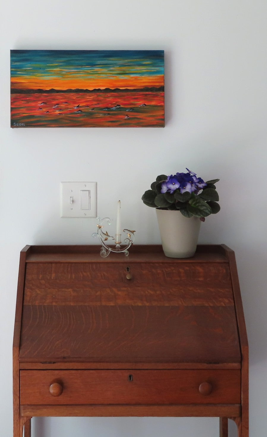 10x20" original oil painting of dolphin pod at sunset, deep cradle canvas, shown over secretary desk