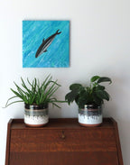 12x12" canvas measures 17x17" when displayed diagnally. The dusky dolhin is a bright focal point on a poured acrylic background which looks remarkably like water.