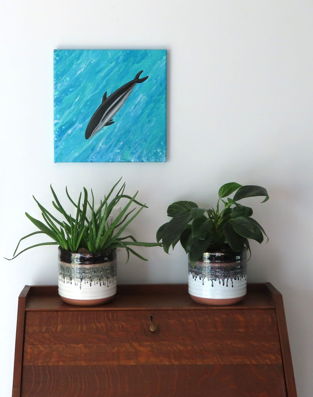 12x12" canvas measures 17x17" when displayed diagnally. The dusky dolhin is a bright focal point on a poured acrylic background which looks remarkably like water.