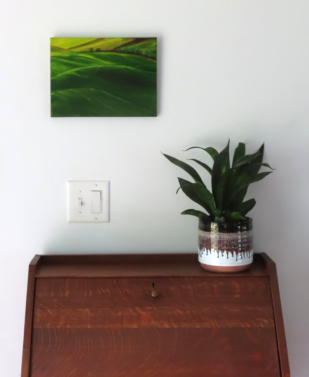 9x12" original oil painting, green rolling hills shown over secretary desk