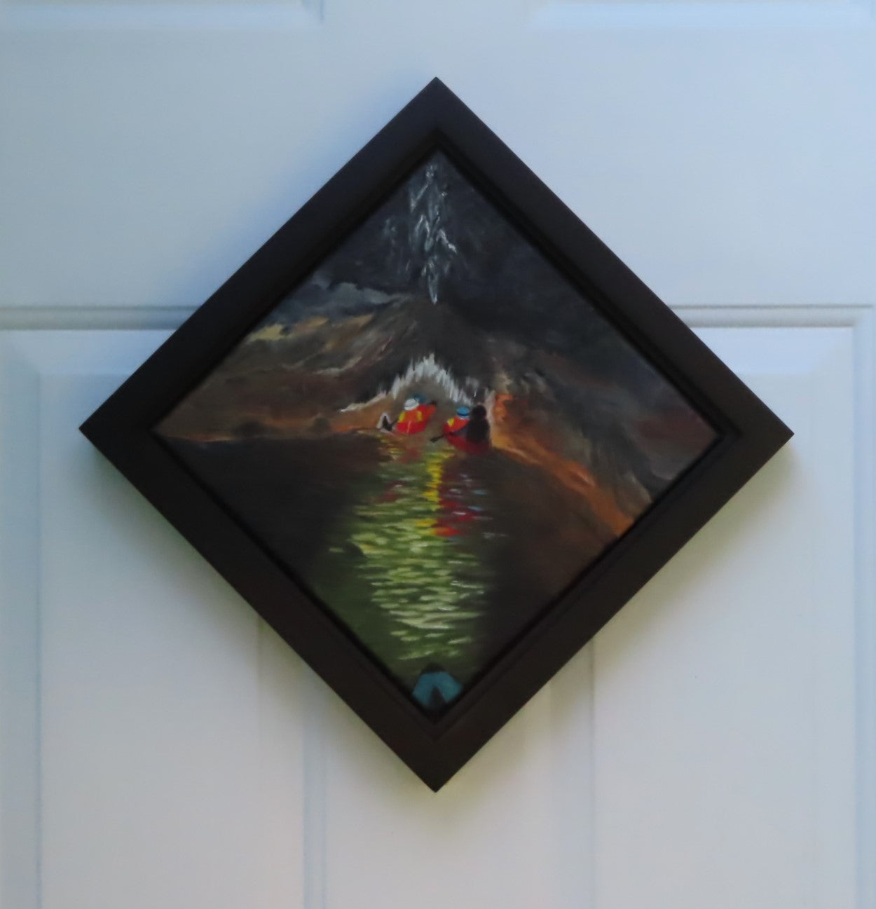 original oil painting of cavers in canoes entering a cave system with river, dark water and walls, accented by light reflections and cave formations, framed in black, diamond presentation