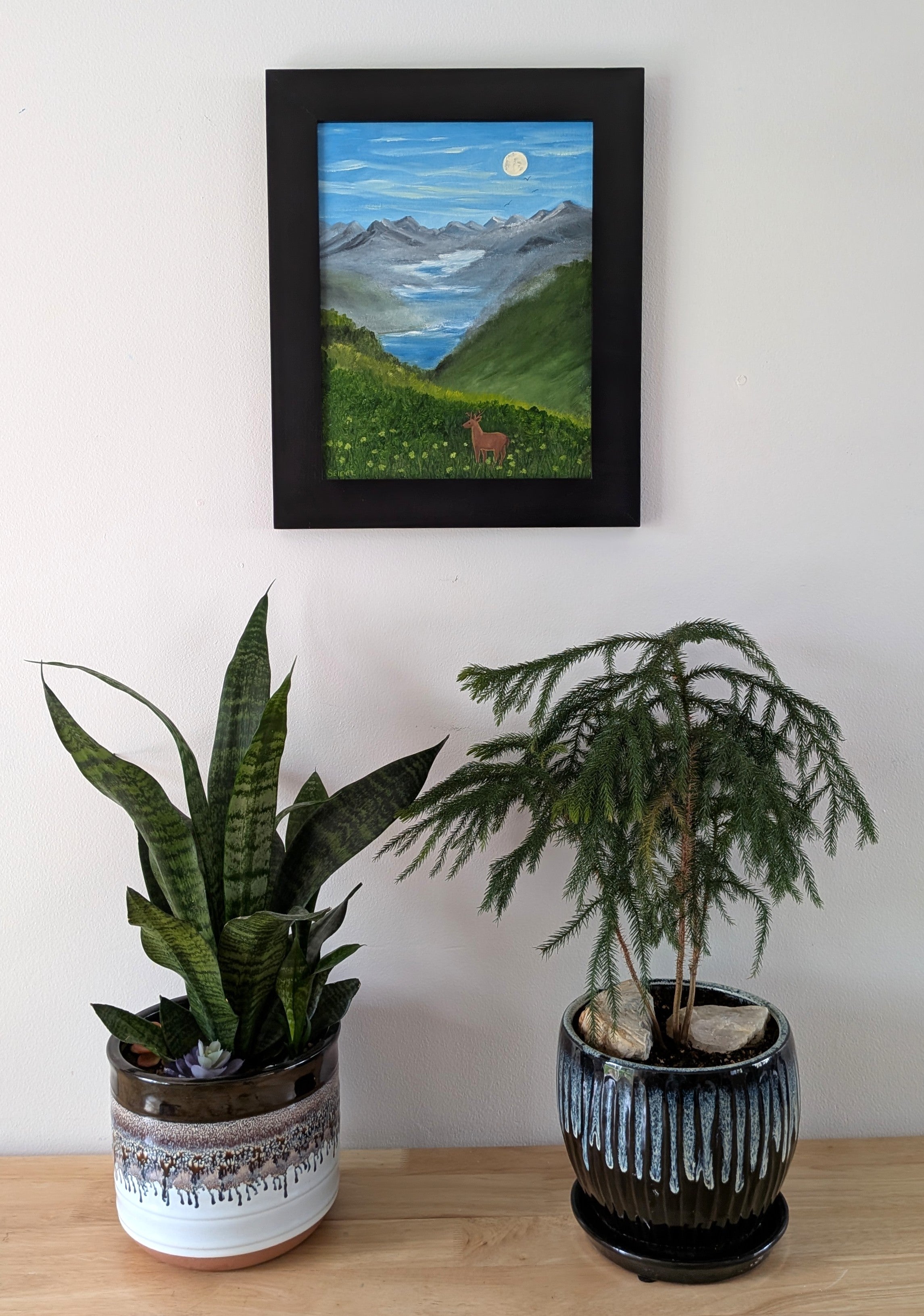 Original oil painting of a misty morning in the mountains, moon, lakes, deer in meadow, framed, shown over table