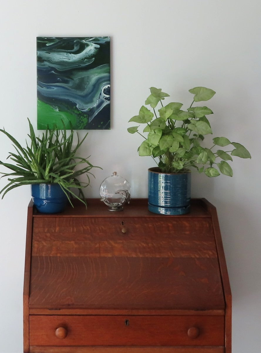 abstract poured acrylic painting on 11x14" canvas, flowing blues, greens and white create movement, second display option, shown over secretary desk