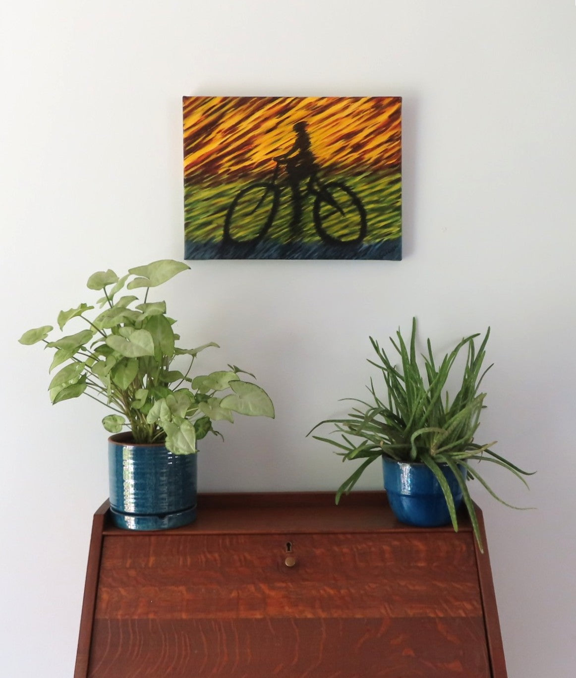 12x16" original abstract acrylic painting, the shadow of a racing bicyclist, shown over a secretary desk