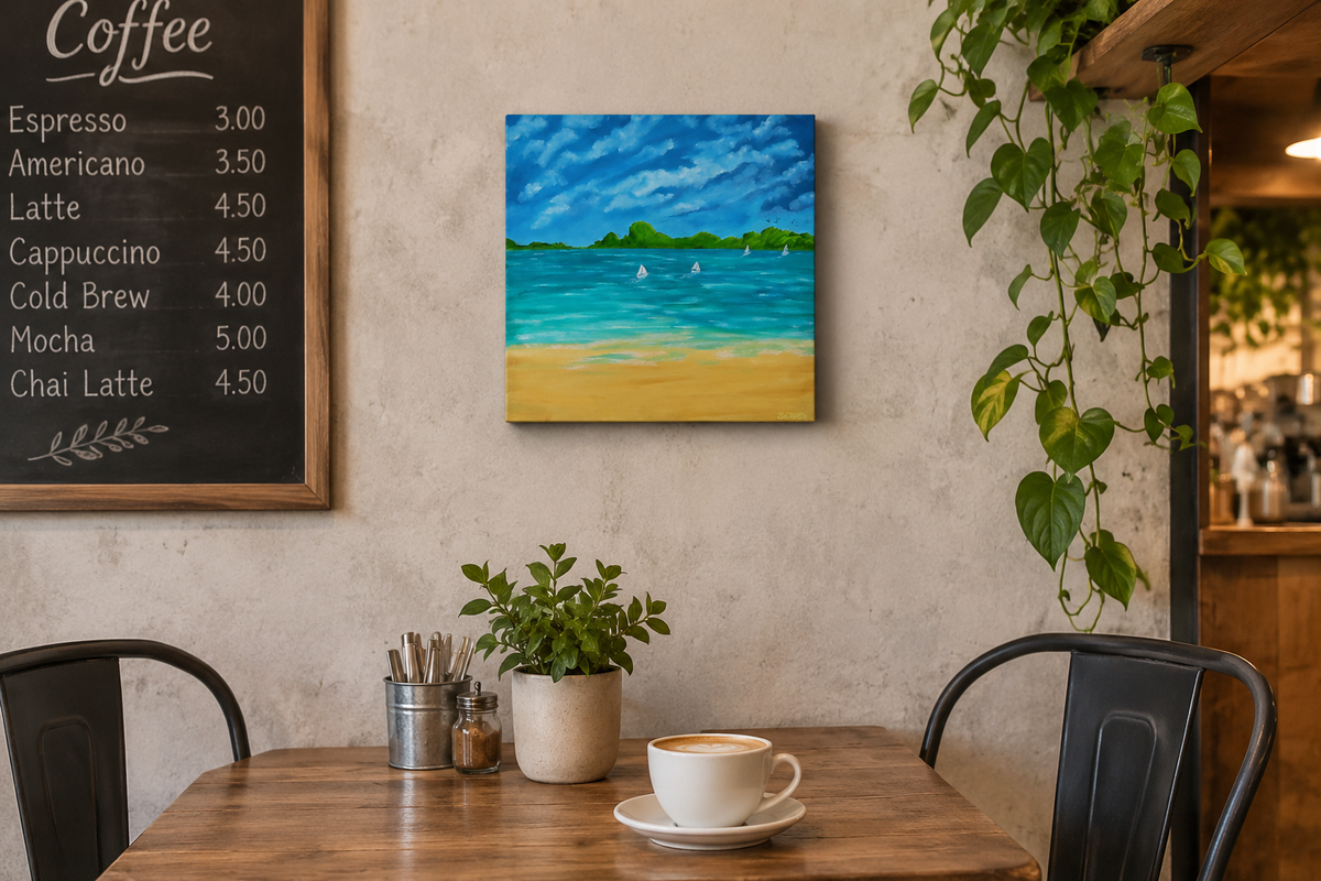 12x12" original oil painting on deep cradle canvas of turquoise ocean, sandy beach with sailboats and mountains in the distance, displayed in a cafe