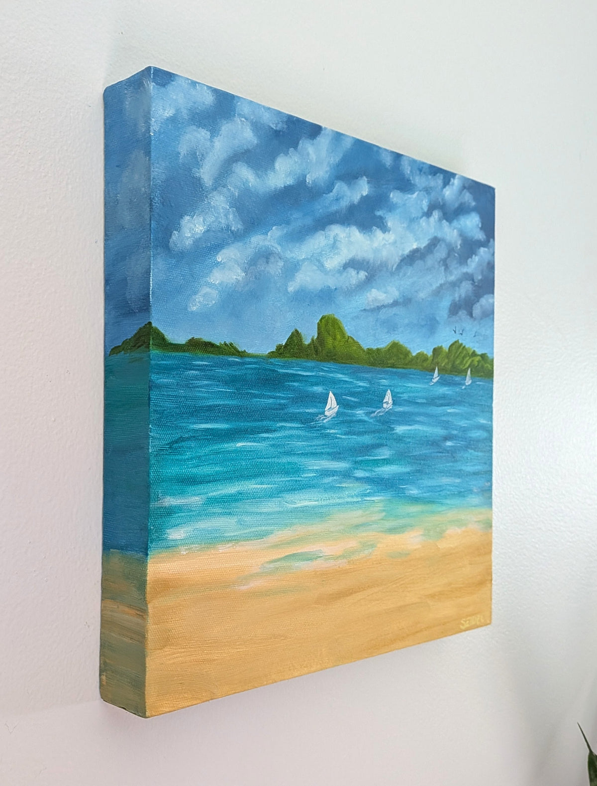 12x12" original oil painting on deep cradle canvas of turquoise ocean, sandy beach with sailboats and mountains in the distance, showing left side