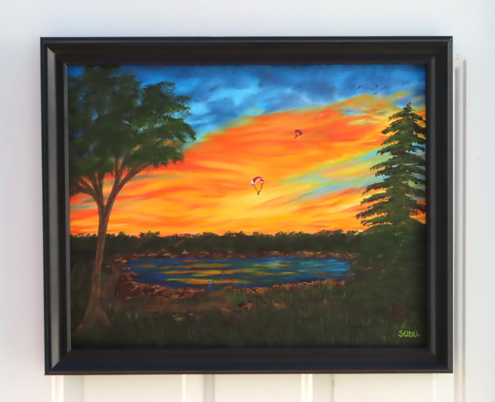 original oil painting, vibrant sunset, lake, trees paragliders flying home, framed