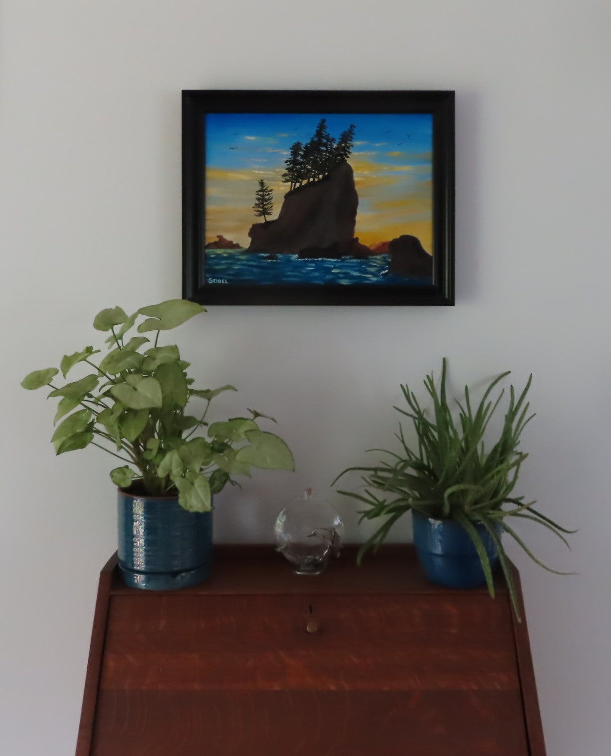 original oil painting, ocean, seastacks, evergreens and beautiful sunset, displayed over desk