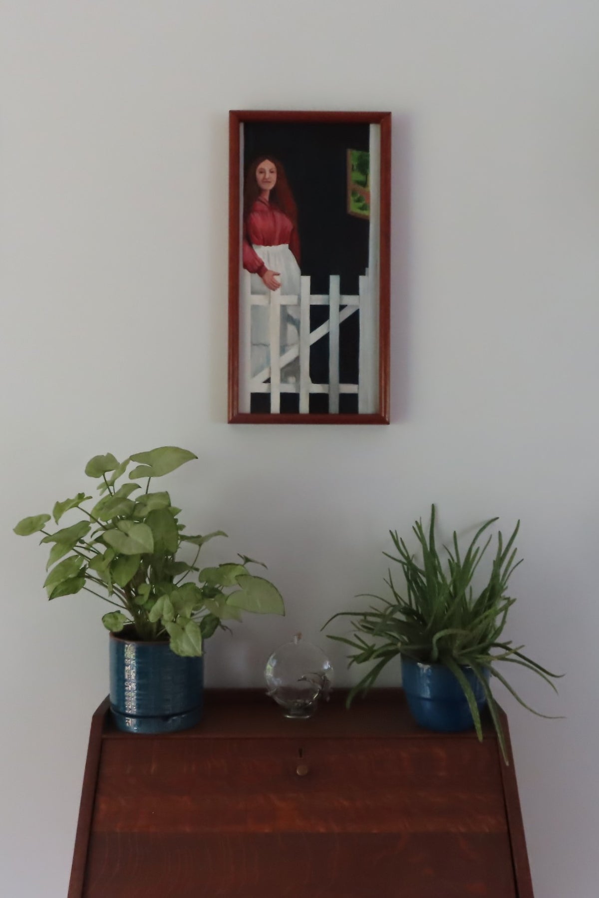 original oil painting of lady in doorway, handmade frame, pictured over secretary desk