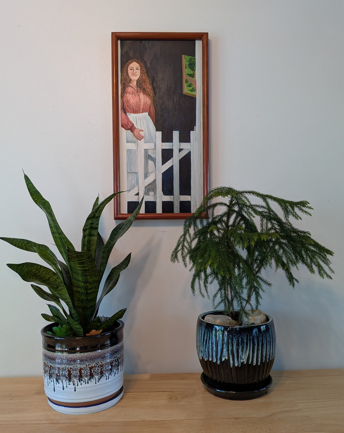 original oil painting of lady in doorway, handmade frame, pictured over table