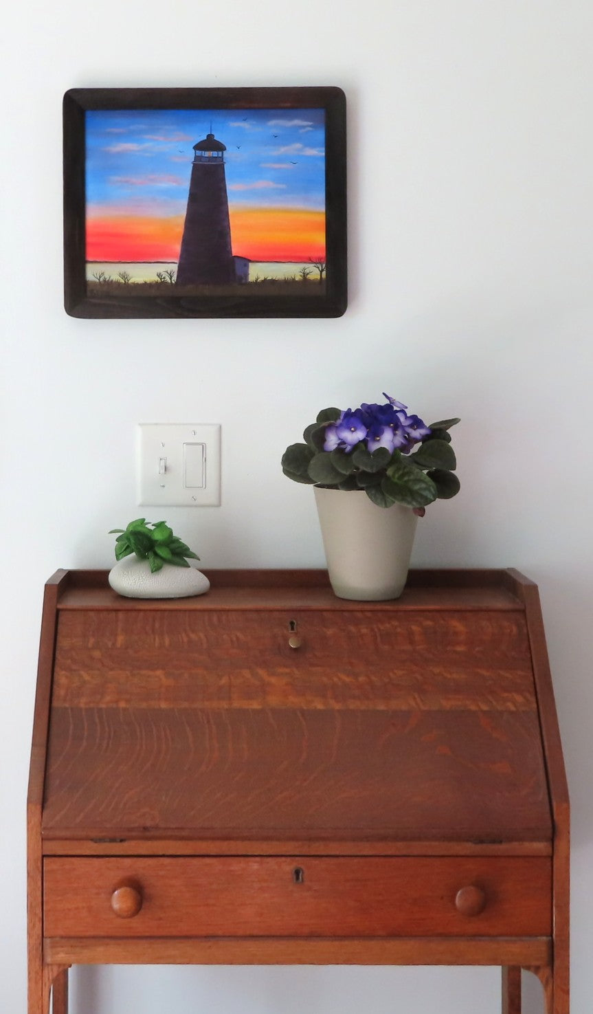 original 8x10" acrylic/mixed media painting,  ocean, sand beach, palm tree, framed in dark wood specialty frame, shown over a secretary desk