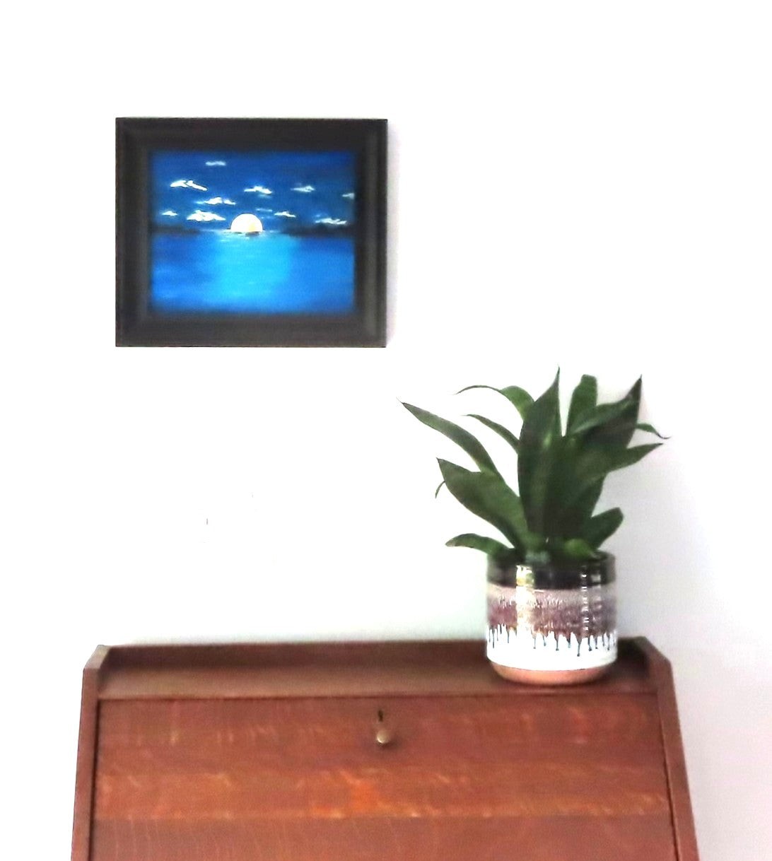 8x10" original acrylic painting, moonrise over ocean, saiboat, headlands, framed, shown over a secretary desk