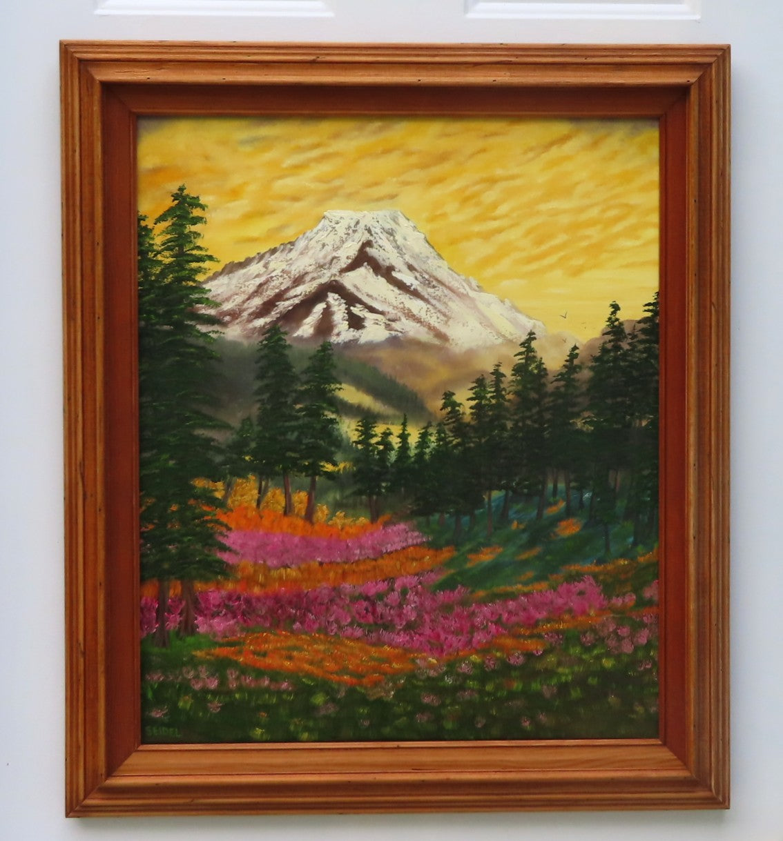 original oil painting of Mt Rainier with evergreen trees, wildflowers and meadows in foreground. framed