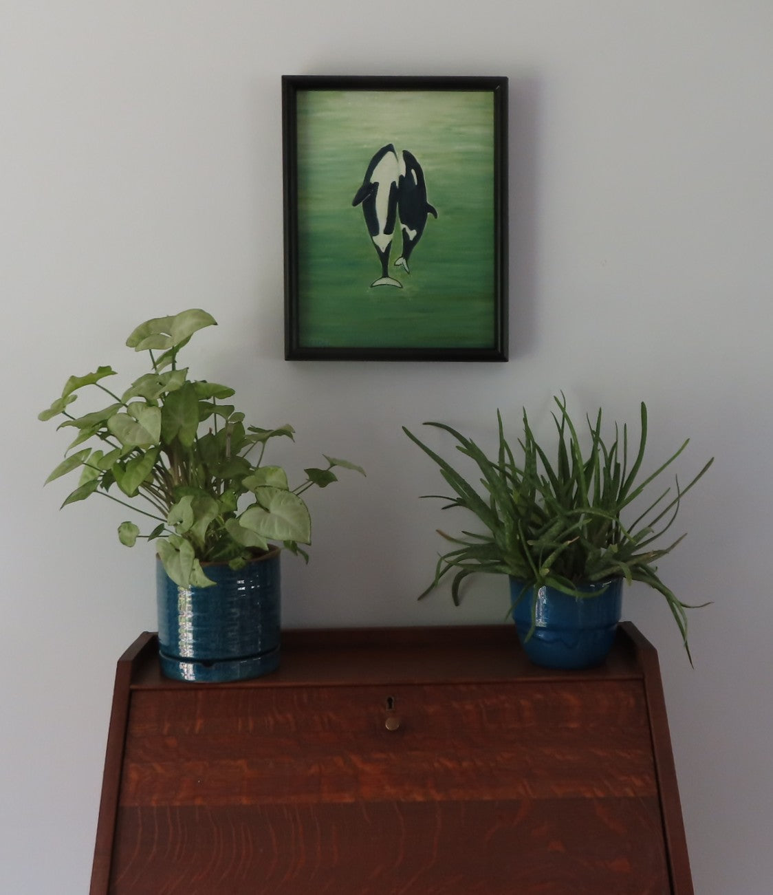 original 11x14 oil painting, two orca whales  seem to dance to the surface of the ocean, framed, displayed over secretary desk.