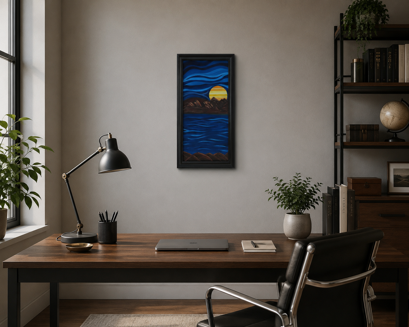 original oil painting, 12 x 24 in an abstracted style, of a bright colored planet rising over the horizon in another world cool blue sky and water framed in black, displayed in front of desk