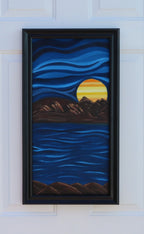 24 x 12 original oil painting, in an abstracted style, of a bright colored planet rising over the horizon in another world with cool blue colors in sky and water framed in modern black frame
