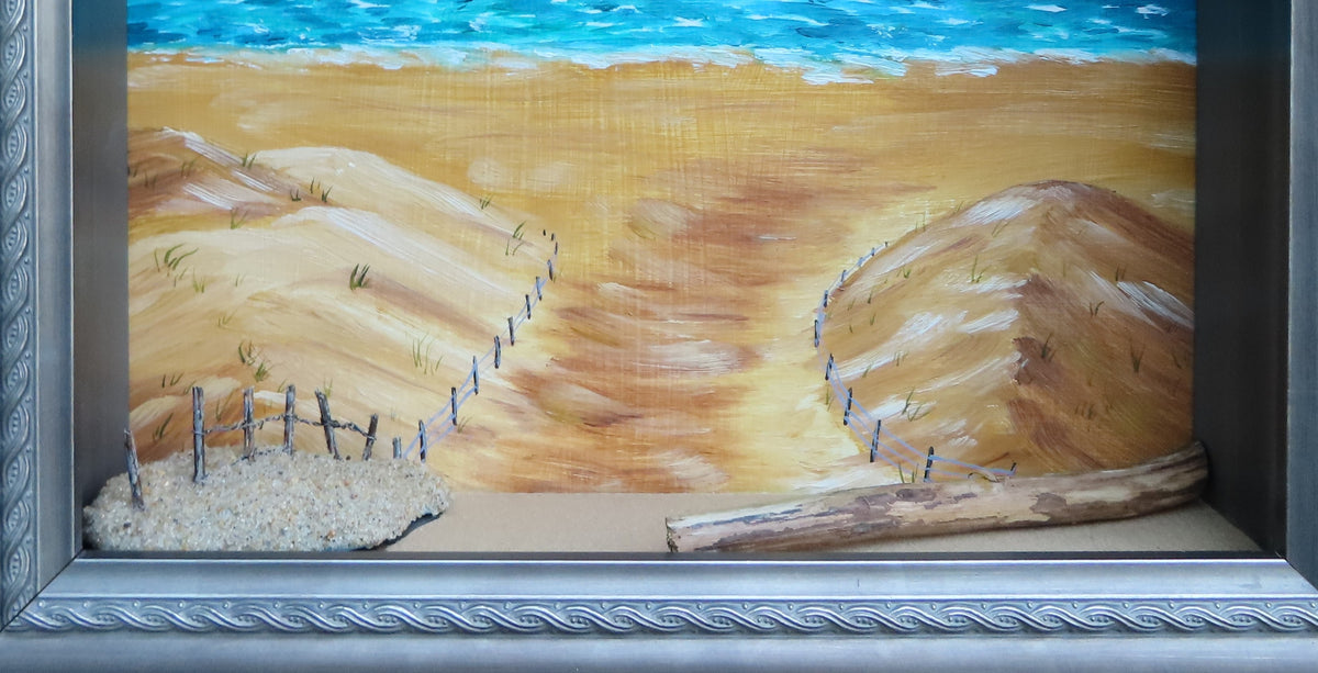 8 1/2 x 10 1/2" by 3" deep shadow box with an original acrylic painting, featuring the Atlantic ocean with sailboats. Mixed media in the foreground features sand a fence and log shown here close-up view.