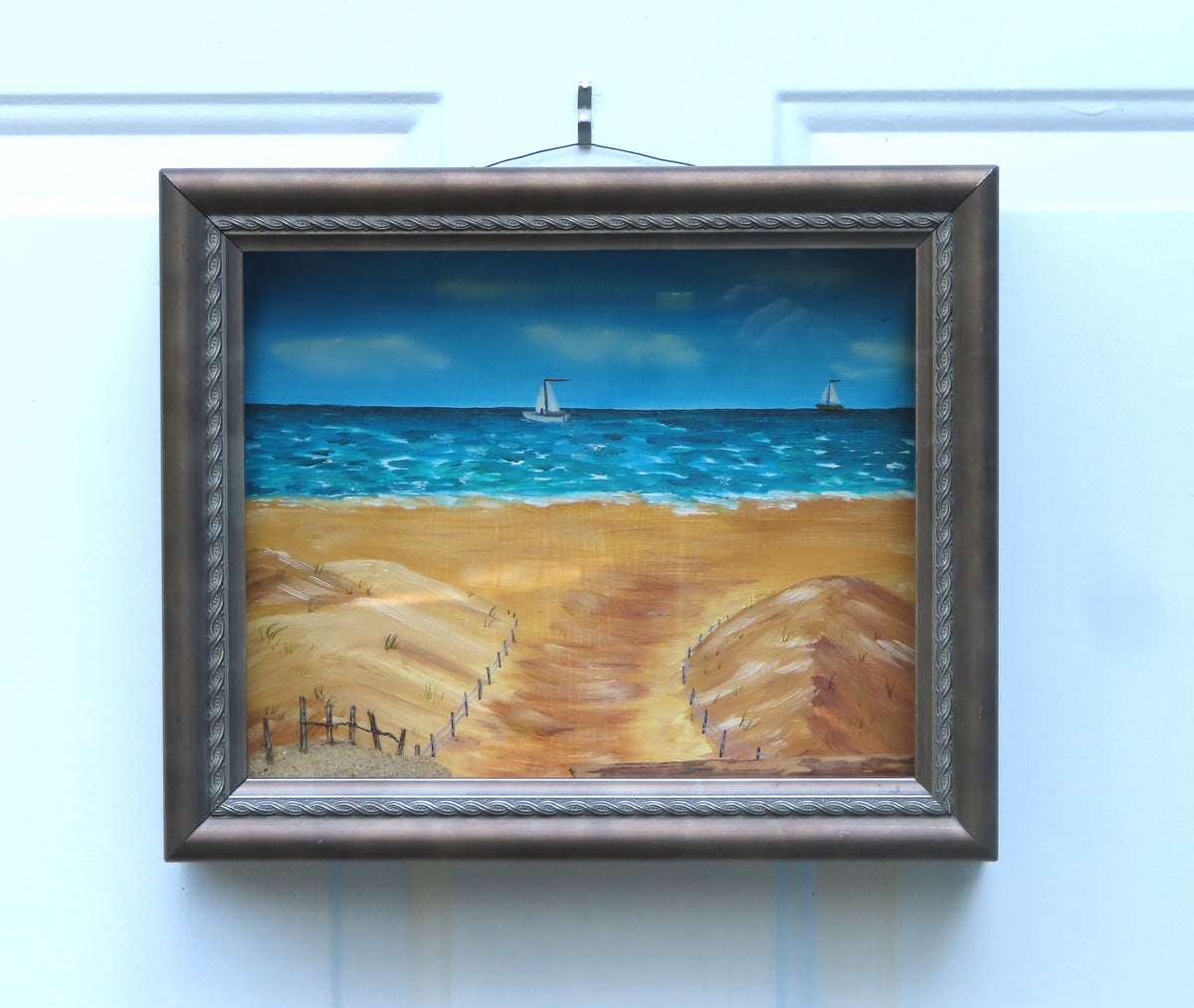 8 1/2 x 10 1/2" by 3" deep shadow box with an original acrylic painting, featuring the Atlantic ocean with sailboats. Mixed media in the foreground features sand a fence and log. 