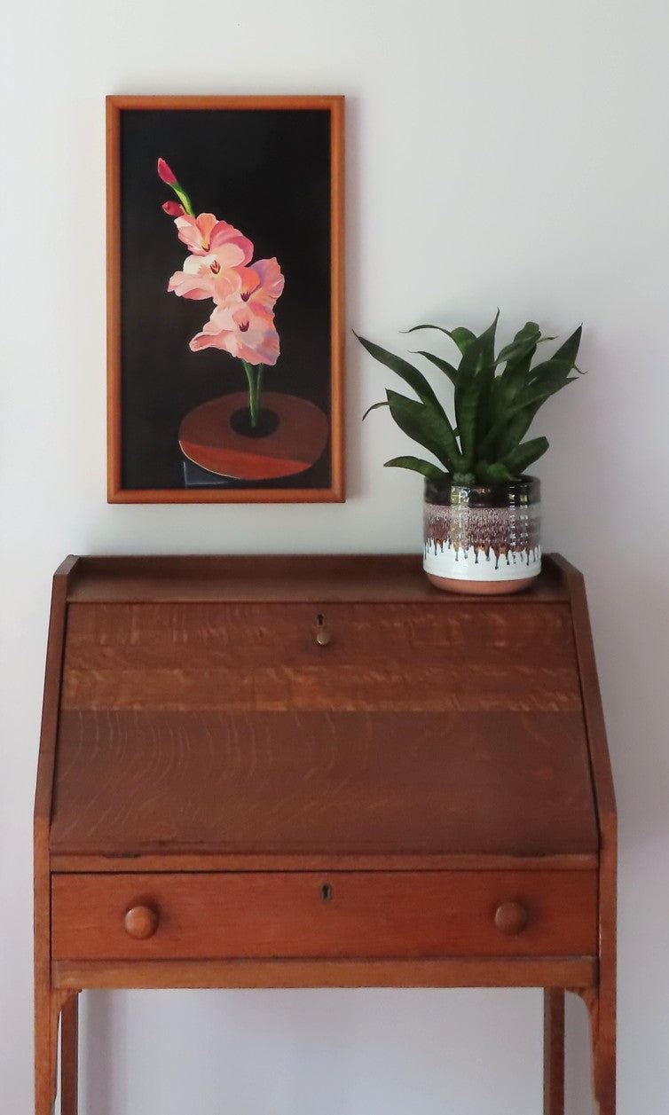 12 x 20 3/4" original oil painting on board, peach gladiolas against dark background, handmade frame, ahown over a secretary desk