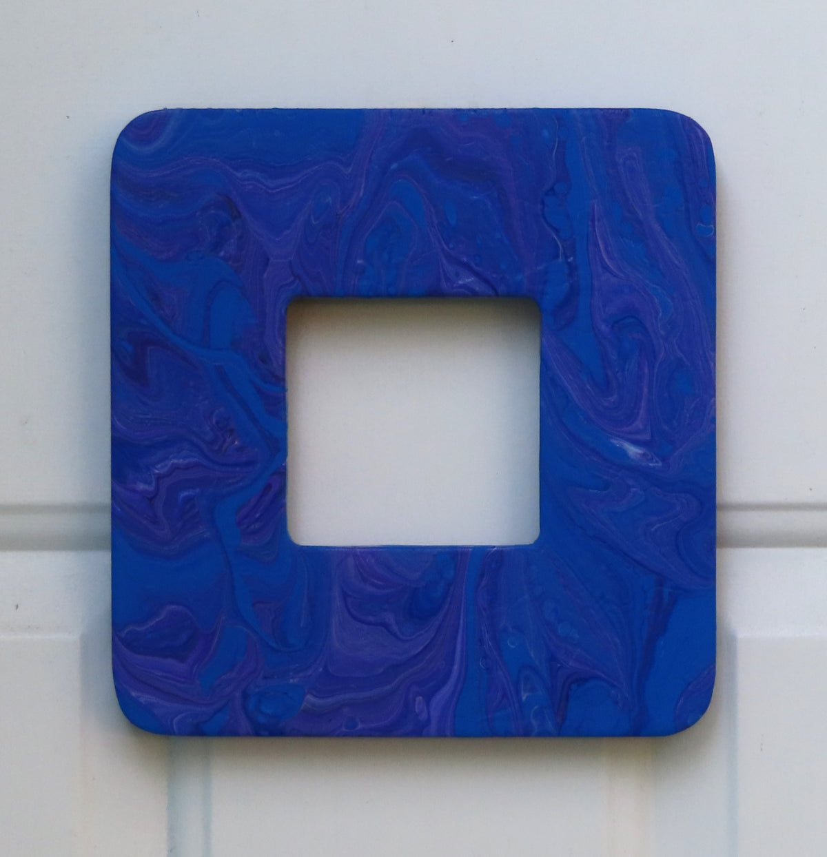 This 7 3/4"- wide by 8" tall has a 3 1/4" by 3 1/4" window for an inspirational quote or a photo of your choice. It is solid wood with an original acrylic poured painting with blues and purples. Shwn here without insert.