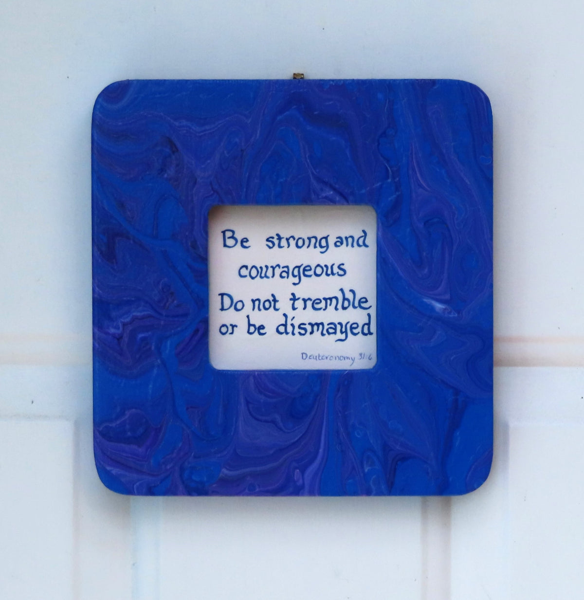 This 7 3/4"- wide by 8" tall has a 3 1/4" by 3 1/4" window for an inspirational quote or a photo of your choice. It is solid wood with an original acrylic poured painting with blues and purples.