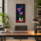 10 1/2x27" original oil painting on board of pink orchids against a royal blue background, in a white pot, framed in a handmade red chestnut colored frame, displayed in an office