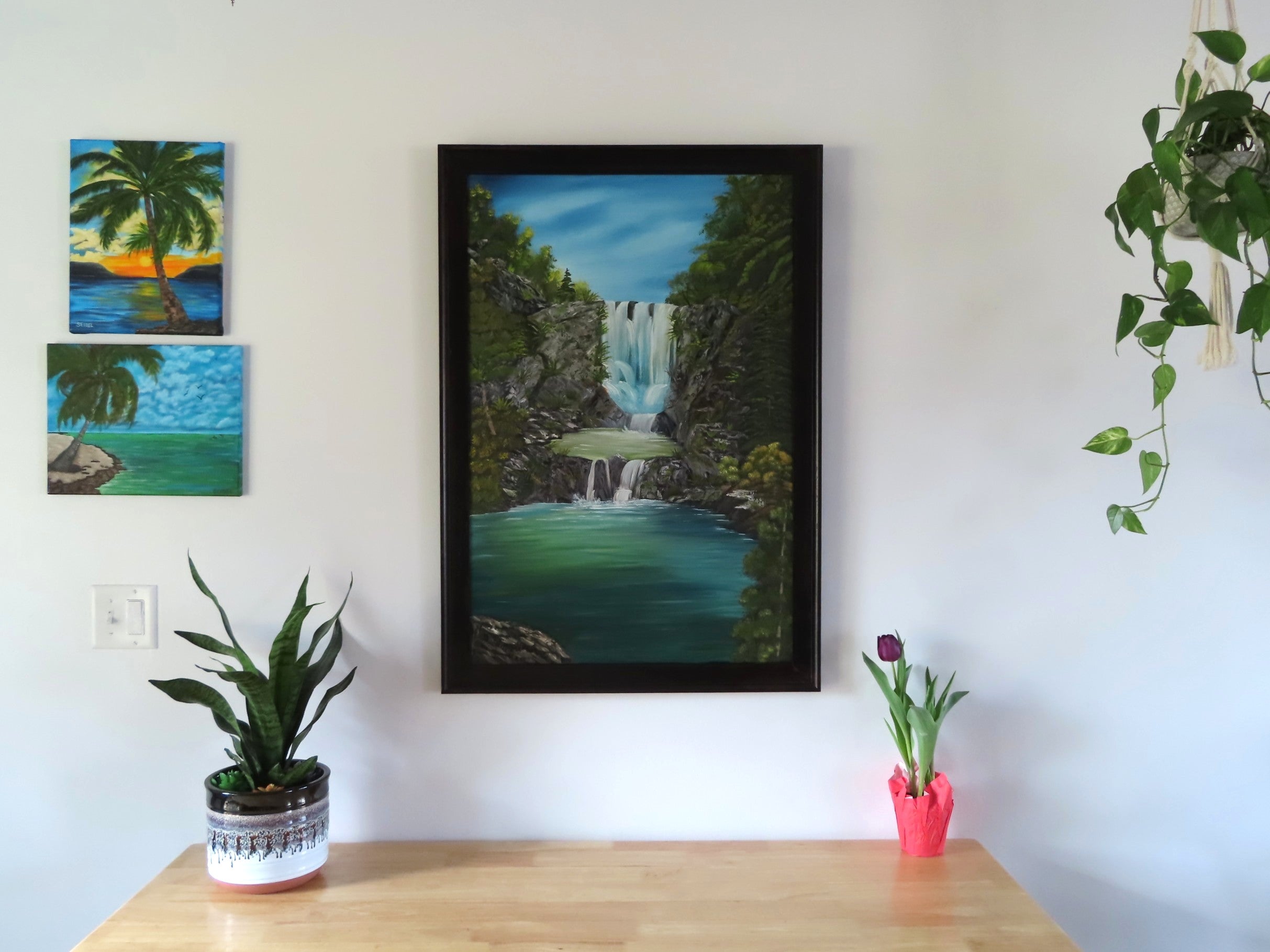 original oil painting of piroa falls new zealand, colorful falls pools and plants, framed in dark wood, over table
