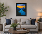 16" wide x 20" tall, original oil painting of river rushing through the mountains under a sunset sky, framed in black, displayed over sofa