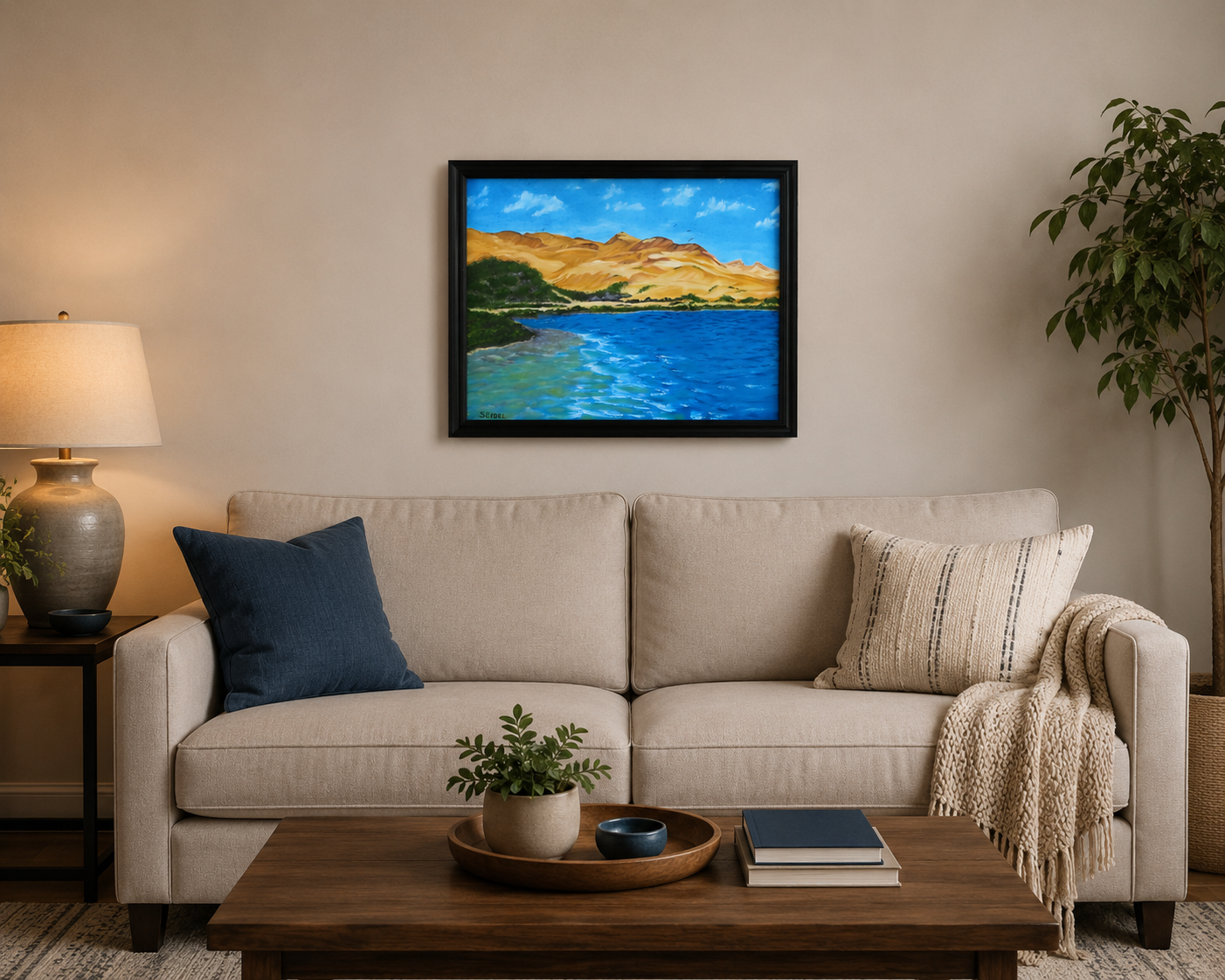 original oil painting of contrasting desert sands meeting the ocean, framed in black displayed over sofa